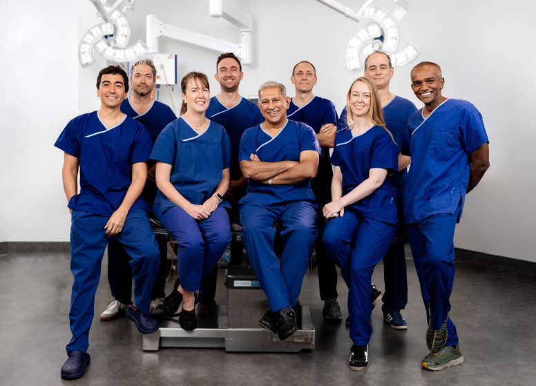 Handoc clinicians standing together in blue scrubs